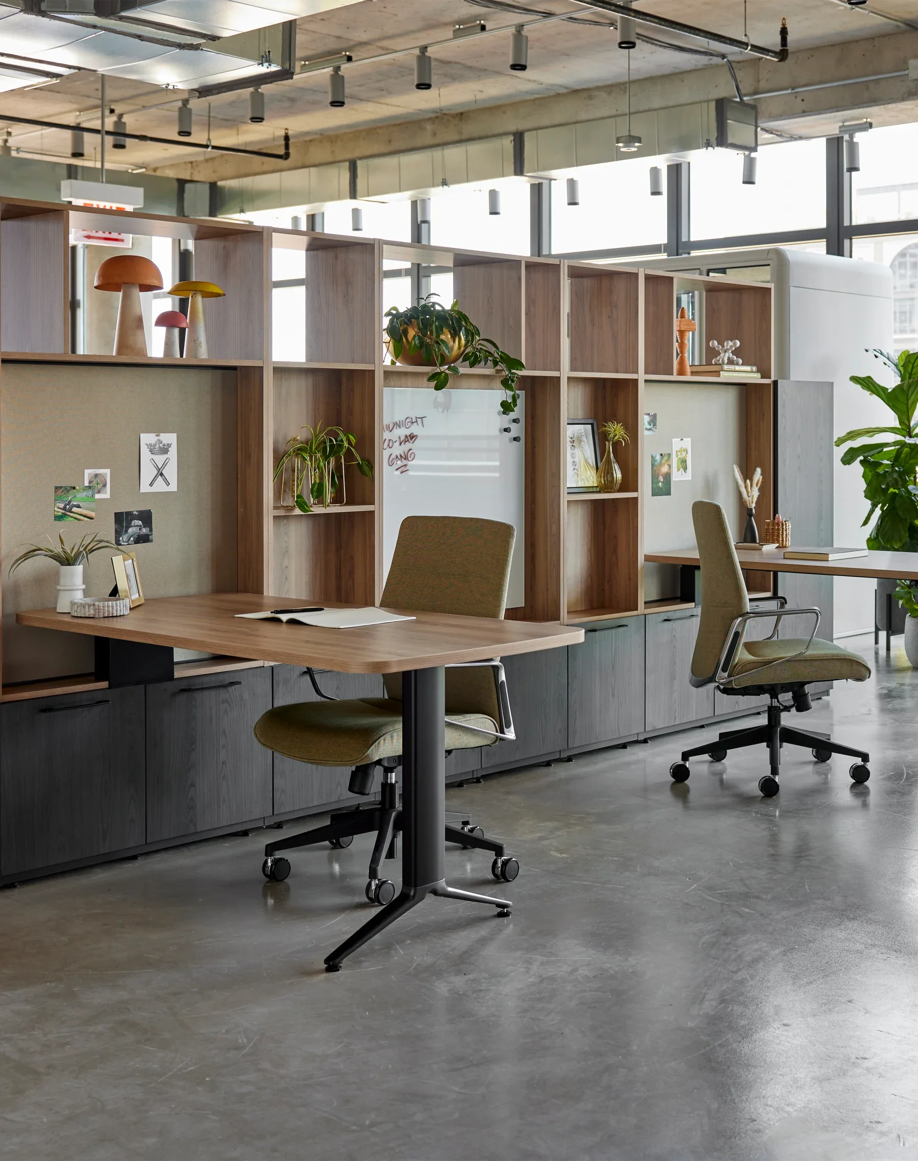 Private office with integrated casegoods, storage, desk, and seating.